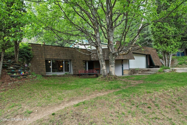 272 Hidden Springs Rd, Sandpoint, ID 83864 - back of house with a lawn and a garage