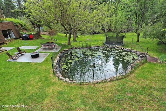 272 Hidden Springs Rd, Sandpoint, ID 83864 - view of yard featuring a trampoline, a fire pit, a patio, a garden pond, and an outdoor structure