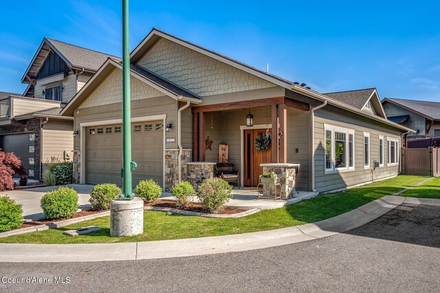1803 W Felton Dr, Coeur Dalene, ID 83814 - view of front of property featuring an attached garage, driveway, a porch, and a front yard