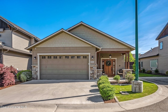 1803 W Felton Dr, Coeur Dalene, ID 83814 - craftsman house featuring stone siding, an attached garage, and driveway