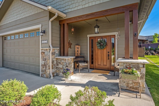 1803 W Felton Dr, Coeur Dalene, ID 83814 - doorway to property featuring a porch, stone siding, and a garage