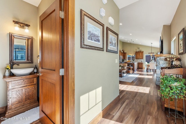1803 W Felton Dr, Coeur Dalene, ID 83814 - corridor featuring a sink, dark wood-style floors, and vaulted ceiling