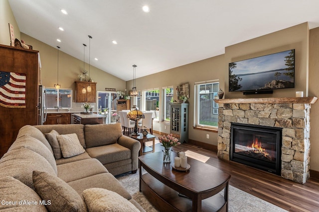 1803 W Felton Dr, Coeur Dalene, ID 83814 - living area featuring wood finished floors, a fireplace, recessed lighting, high vaulted ceiling, and baseboards