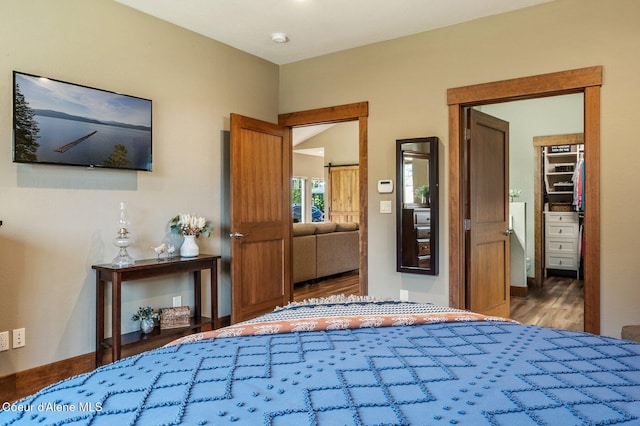 1803 W Felton Dr, Coeur Dalene, ID 83814 - bedroom with wood finished floors and a walk in closet