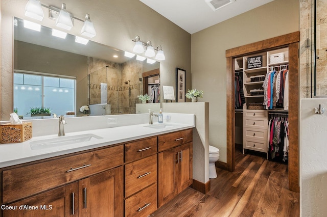 1803 W Felton Dr, Coeur Dalene, ID 83814 - full bath featuring a spacious closet, double vanity, a stall shower, wood finished floors, and toilet
