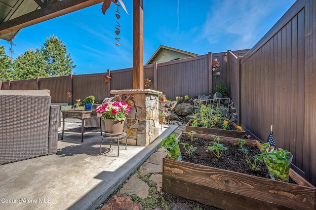 1803 W Felton Dr, Coeur Dalene, ID 83814 - fenced backyard featuring a vegetable garden and a patio