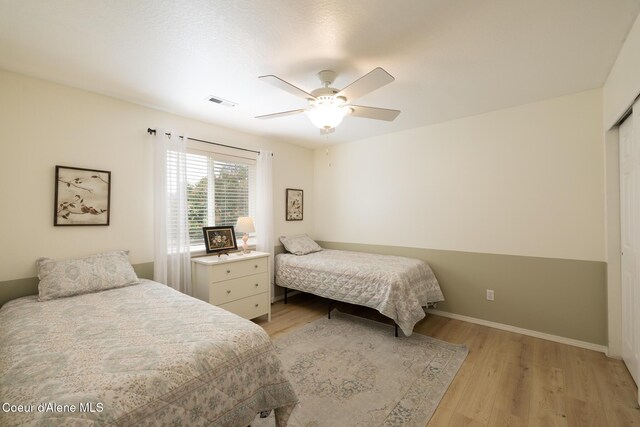 9105 N Prescott Dr, Hayden, ID 83835 - bedroom with light wood-style floors, baseboards, a ceiling fan, and a closet