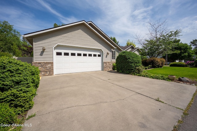 10016 N Zack Ct, Hayden, ID 83835 - view of front of house with brick siding, a front lawn, and concrete driveway