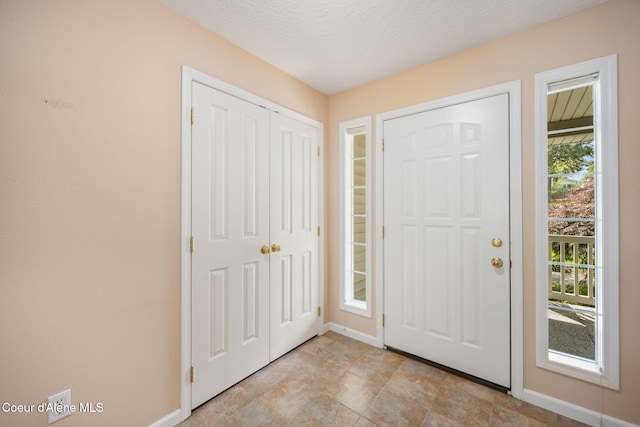10016 N Zack Ct, Hayden, ID 83835 - entrance foyer with baseboards and stone finish flooring