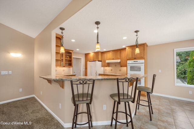 10016 N Zack Ct, Hayden, ID 83835 - kitchen featuring white appliances, open shelves, light stone counters, a peninsula, and a breakfast bar