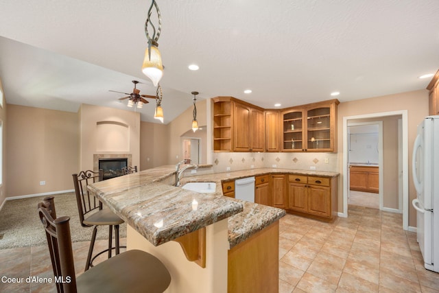 10016 N Zack Ct, Hayden, ID 83835 - kitchen with a peninsula, white appliances, ceiling fan, open shelves, and a kitchen breakfast bar