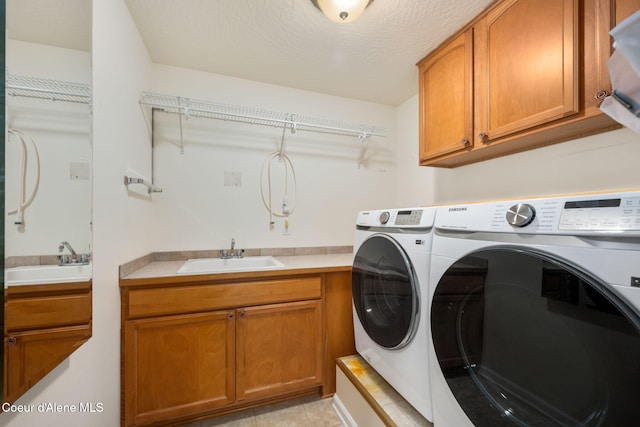 10016 N Zack Ct, Hayden, ID 83835 - laundry room with separate washer and dryer, cabinet space, and light tile patterned flooring