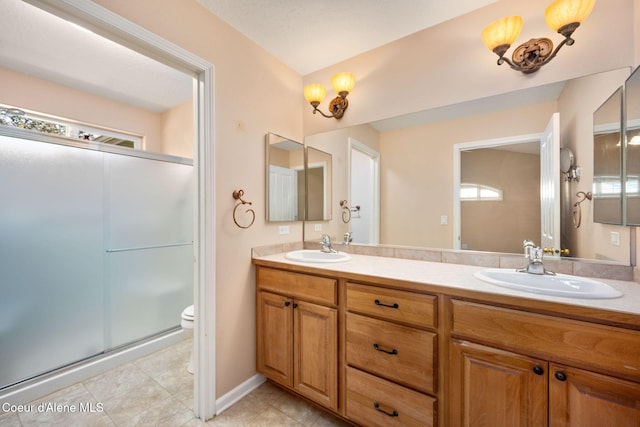 10016 N Zack Ct, Hayden, ID 83835 - bathroom with double vanity, a shower stall, plenty of natural light, and tile patterned floors