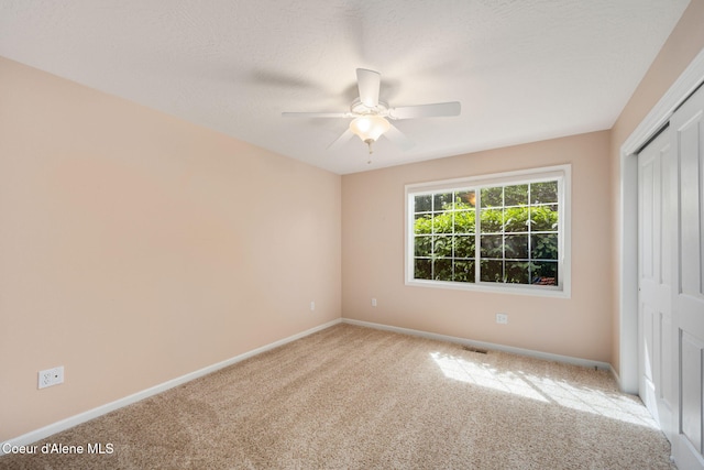 10016 N Zack Ct, Hayden, ID 83835 - unfurnished bedroom with carpet, a closet, and ceiling fan