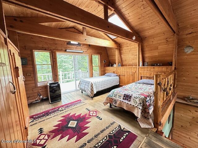 474 NW Fork Santa Creek Rd, Emida, ID 83861 - bedroom with wood walls, wood-type flooring, wood ceiling, and access to exterior