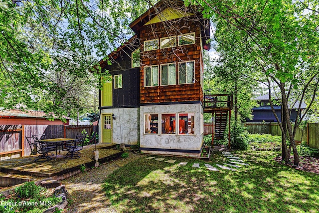 913 Cedar St, Sandpoint, ID 83864 - back of house featuring a wooden deck, stairs, and stucco siding