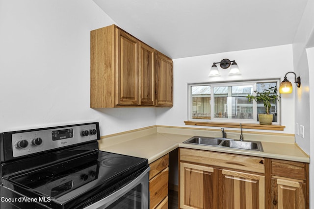913 Cedar St, Sandpoint, ID 83864 - kitchen featuring stainless steel range with electric stovetop, a sink, light countertops, and brown cabinetry
