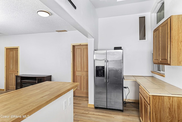 913 Cedar St, Sandpoint, ID 83864 - kitchen with stainless steel fridge, light wood-style flooring, and brown cabinetry