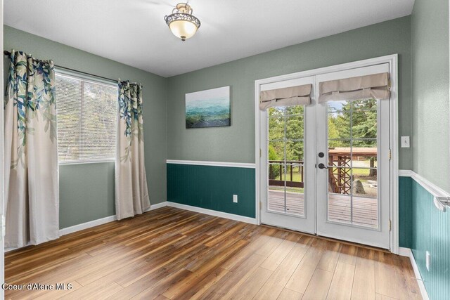 31716 N Middle Ave, Spirit Lake, ID 83869 - unfurnished room featuring wood finished floors, french doors, and baseboards