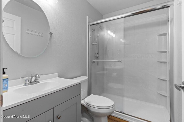 31716 N Middle Ave, Spirit Lake, ID 83869 - full bathroom with vanity, a shower stall, and toilet