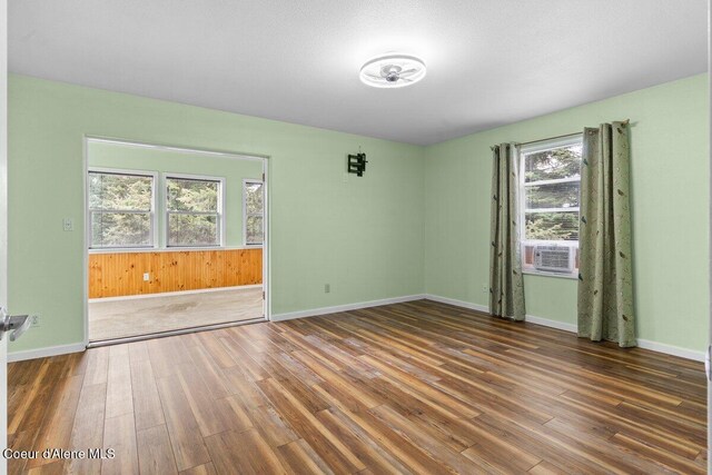 31716 N Middle Ave, Spirit Lake, ID 83869 - empty room featuring wood finished floors, baseboards, and cooling unit