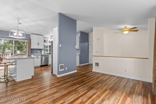 31716 N Middle Ave, Spirit Lake, ID 83869 - kitchen with stainless steel dishwasher, a kitchen breakfast bar, dark wood finished floors, and white cabinetry
