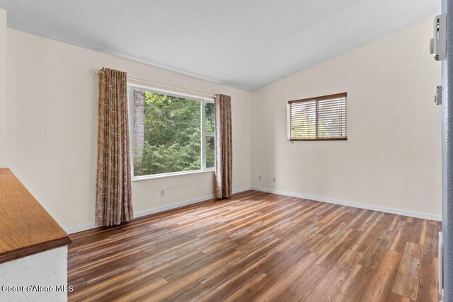 31716 N Middle Ave, Spirit Lake, ID 83869 - empty room featuring vaulted ceiling, wood finished floors, and baseboards