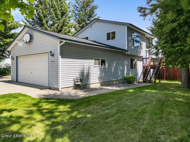 31716 N Middle Ave, Spirit Lake, ID 83869 - view of side of home featuring stairs, driveway, a wooden deck, and a garage