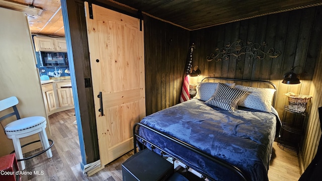 33671 N Macdonalds Unit 2Nd, Dock, Bayview, ID 83803 - bedroom with wood finished floors, wood ceiling, and wooden walls