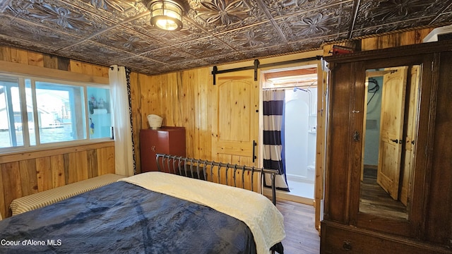33671 N Macdonalds Unit 2Nd, Dock, Bayview, ID 83803 - bedroom with wood walls, an ornate ceiling, and wood finished floors