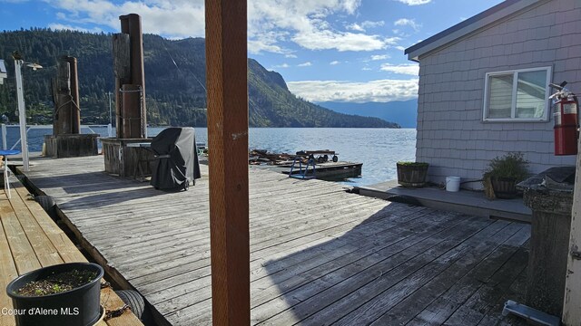 33671 N Macdonalds Unit 2Nd, Dock, Bayview, ID 83803 - wooden terrace featuring a water and mountain view and a dock