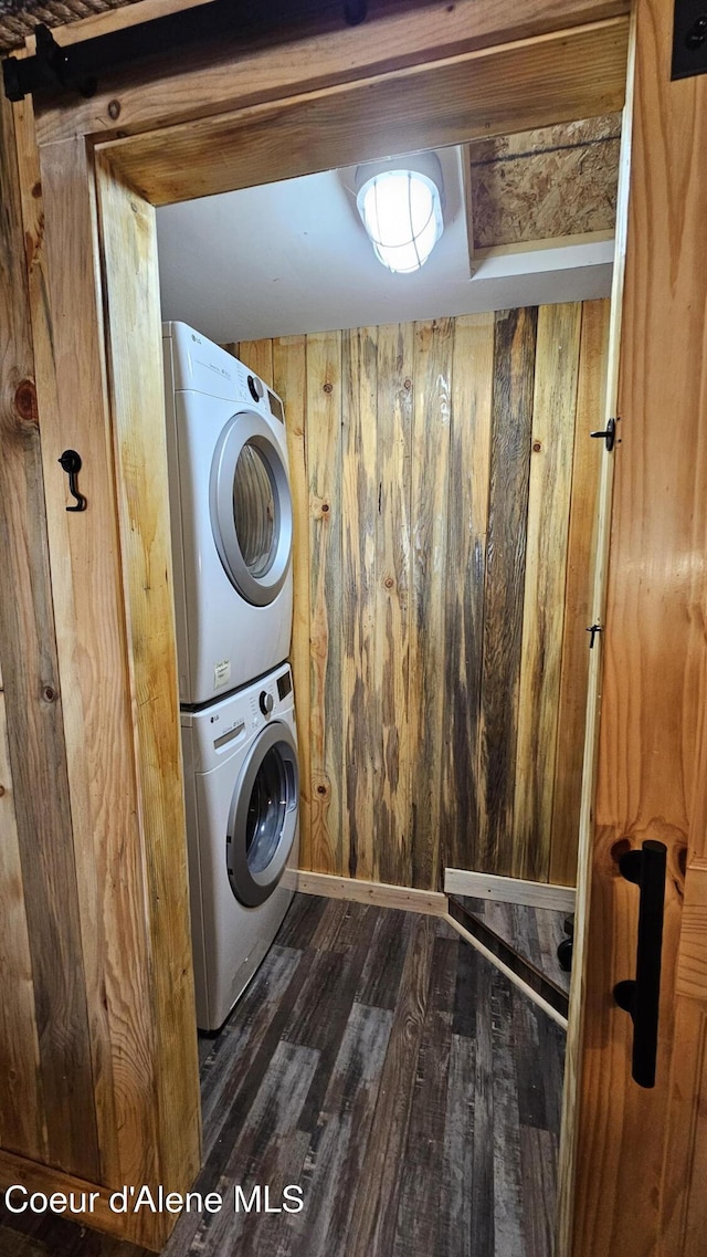 33671 N Macdonalds Unit 2Nd, Dock, Bayview, ID 83803 - washroom featuring stacked washer and clothes dryer, wood finished floors, and wooden walls