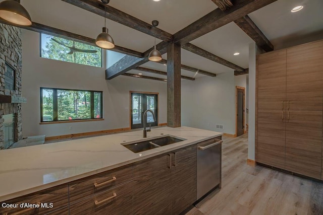 74 Wedge Ct, Priest Lake, ID 83856 - kitchen with a sink, beam ceiling, light wood-type flooring, dishwasher, and pendant lighting