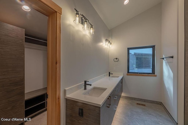 74 Wedge Ct, Priest Lake, ID 83856 - full bathroom with vaulted ceiling, double vanity, baseboards, and recessed lighting