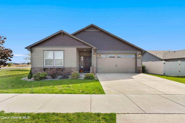 4447 N Connery Loop, Post Falls, ID 83854 - craftsman inspired home featuring stone siding, an attached garage, and driveway