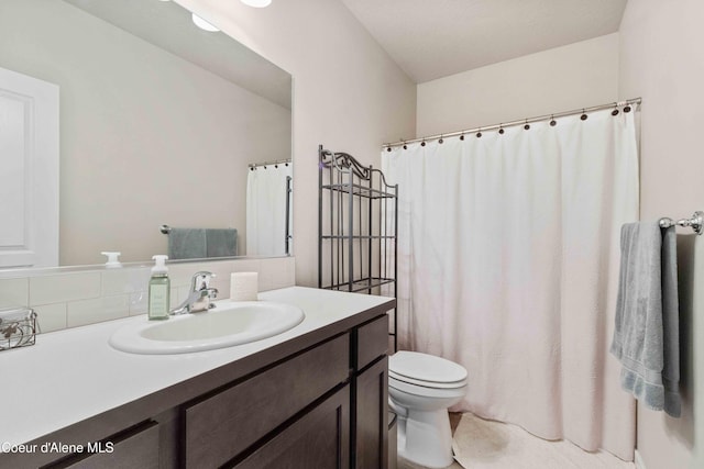 4447 N Connery Loop, Post Falls, ID 83854 - bathroom featuring toilet, vanity, backsplash, and curtained shower