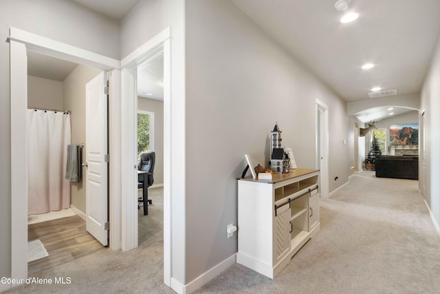 4447 N Connery Loop, Post Falls, ID 83854 - hallway featuring light colored carpet, arched walkways, recessed lighting, and baseboards
