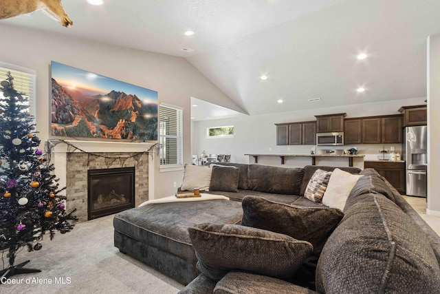 4447 N Connery Loop, Post Falls, ID 83854 - living room with lofted ceiling, light colored carpet, recessed lighting, and a fireplace