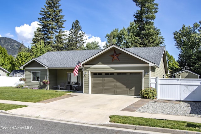 318 Huppert Ln, Sandpoint, ID 83864 - single story home with roof with shingles, an attached garage, and concrete driveway