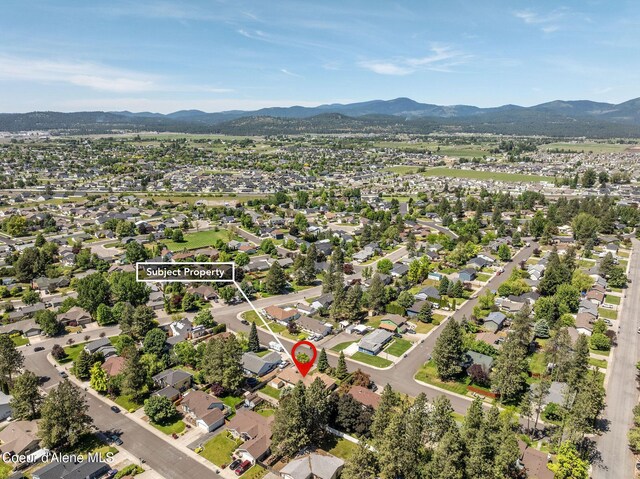 407 W Musket Ave, Post Falls, ID 83854 - aerial view of property and surrounding area with a mountainous background and nearby suburban area