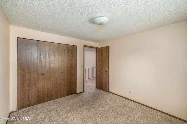 407 W Musket Ave, Post Falls, ID 83854 - unfurnished bedroom with carpet floors, a closet, and a textured ceiling