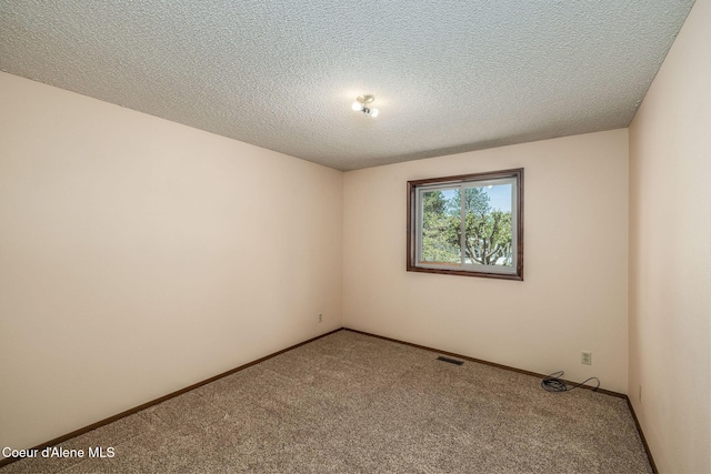 407 W Musket Ave, Post Falls, ID 83854 - carpeted spare room featuring baseboards and a textured ceiling