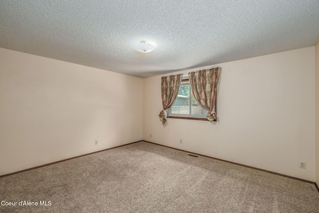 407 W Musket Ave, Post Falls, ID 83854 - unfurnished room featuring carpet floors, a textured ceiling, and baseboards