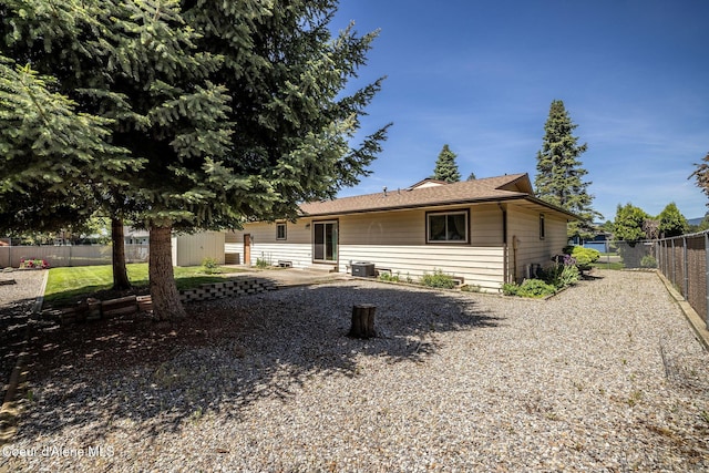 407 W Musket Ave, Post Falls, ID 83854 - view of front facade featuring a fenced backyard, cooling unit, and a patio area