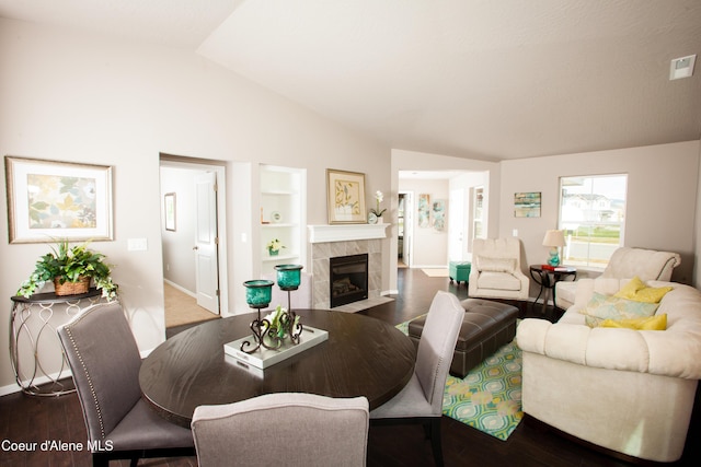 2142 W Cholet Ln, Coeur Dalene, ID 83815 - living room featuring vaulted ceiling, wood finished floors, a tiled fireplace, and baseboards