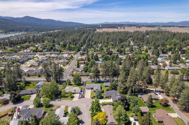 3623 W Hillcrest Cir, Coeur Dalene, ID 83815 - aerial view of property and surrounding area with a mountainous background, a heavily wooded area, and nearby suburban area