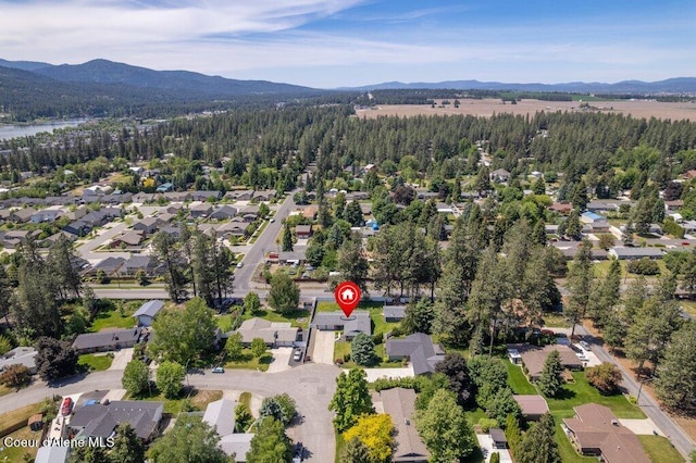3623 W Hillcrest Cir, Coeur Dalene, ID 83815 - aerial overview of property's location featuring a mountainous background, a forest, and nearby suburban area
