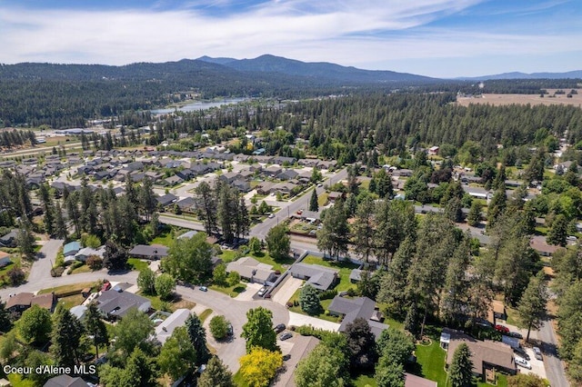 3623 W Hillcrest Cir, Coeur Dalene, ID 83815 - aerial overview of property's location featuring a forest, a mountainous background, and nearby suburban area
