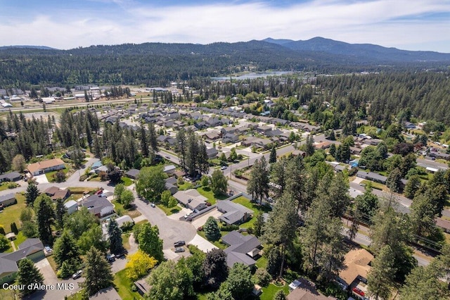 3623 W Hillcrest Cir, Coeur Dalene, ID 83815 - aerial view of property's location with a heavily wooded area, mountains, and nearby suburban area