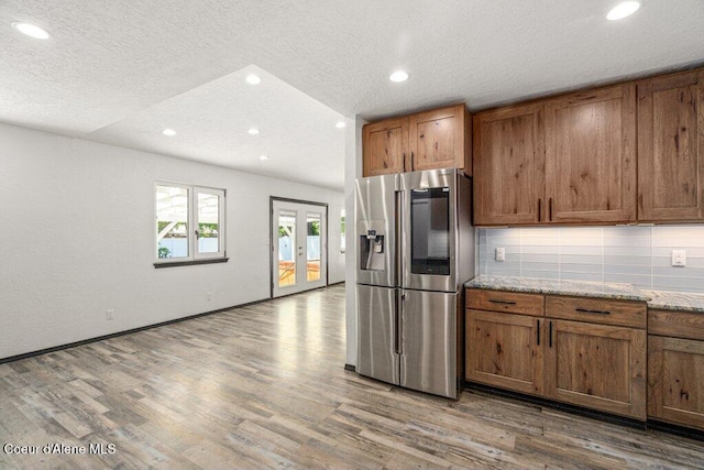 3623 W Hillcrest Cir, Coeur Dalene, ID 83815 - kitchen featuring stainless steel fridge with ice dispenser, brown cabinets, recessed lighting, wood finished floors, and a textured ceiling
